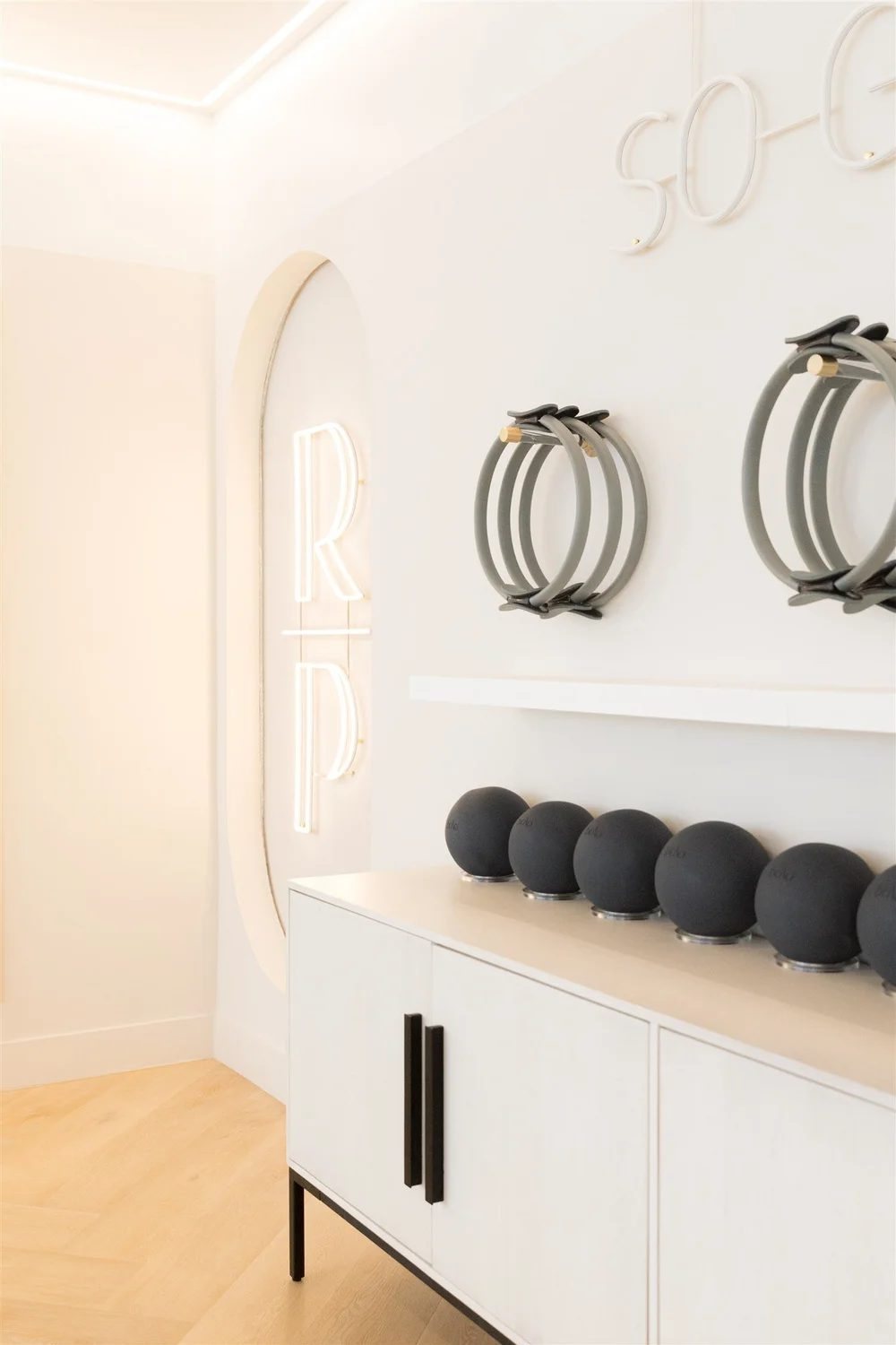 Storage cabinet with Pilates rings and weights