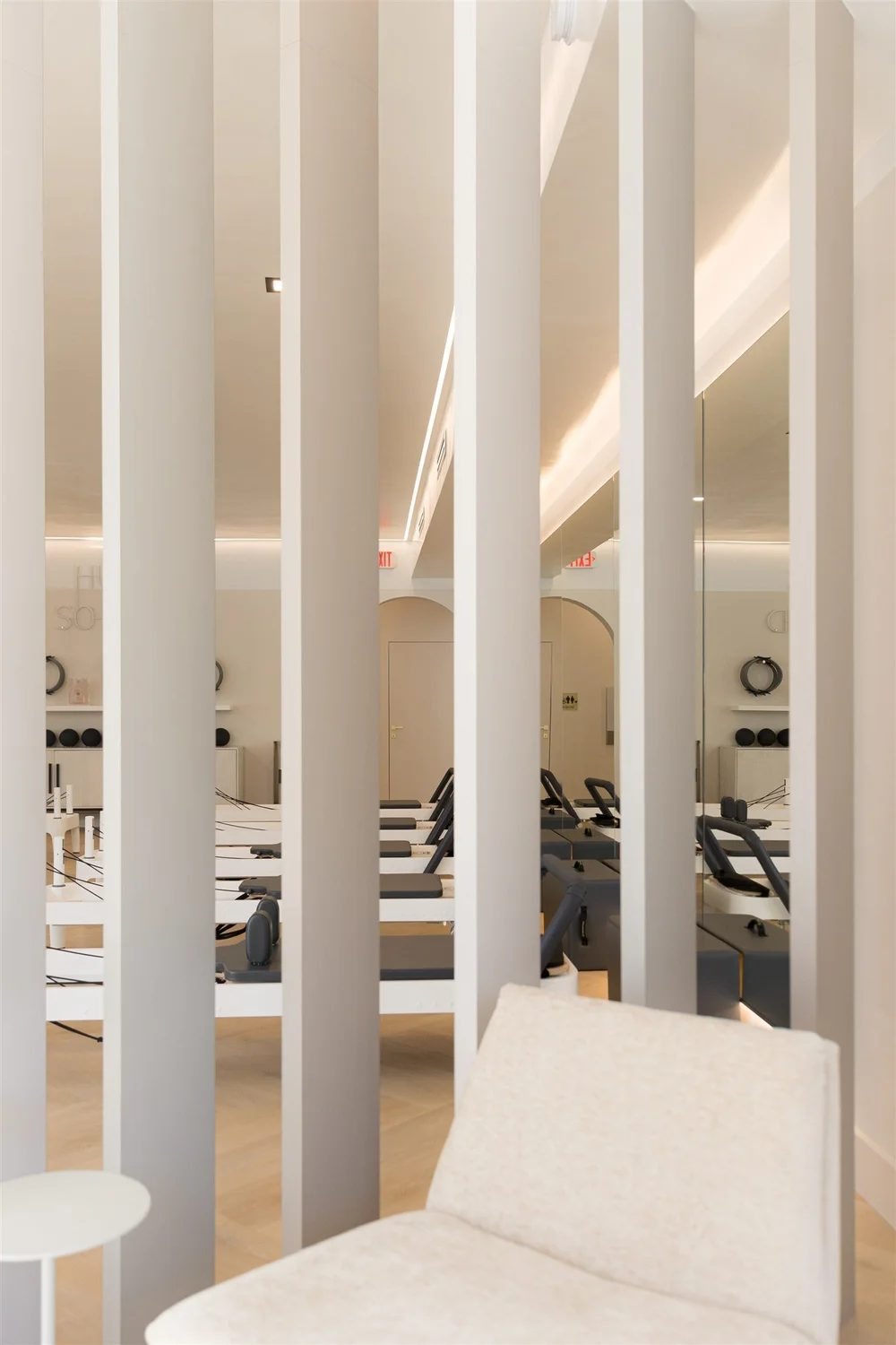 Slatted columns beside a cream lounge chair